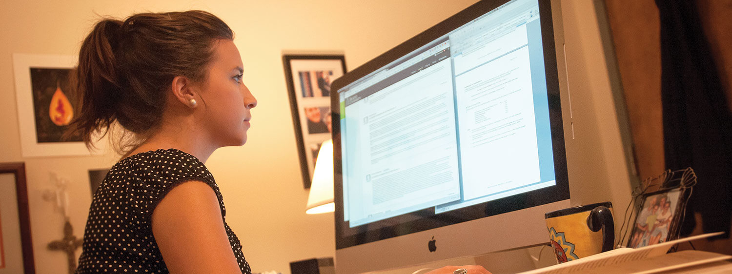 A student looks at documents on her computer.