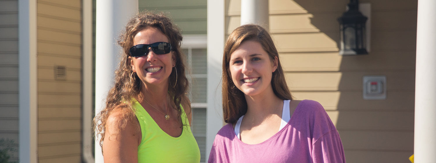 A student and her mother outside Regent's student housing building.