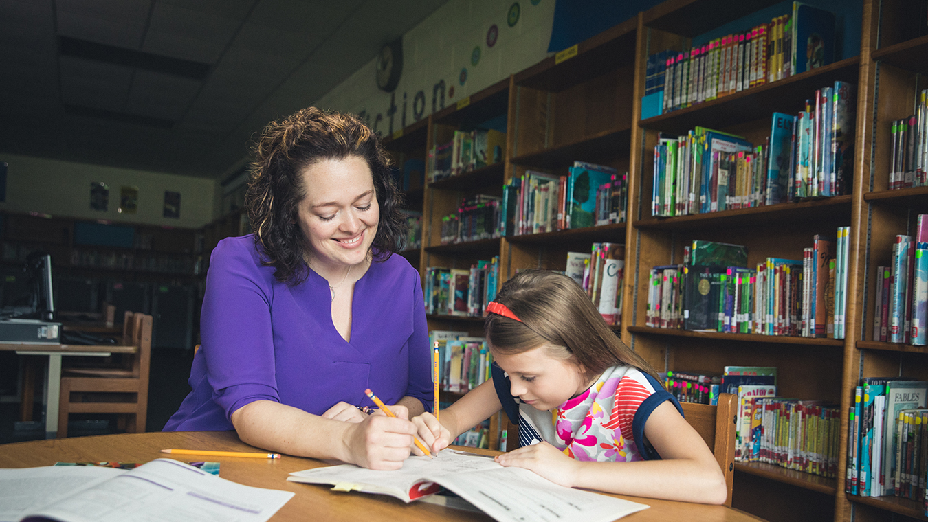 A alumnus of Regent University's School of Education teaches a student.