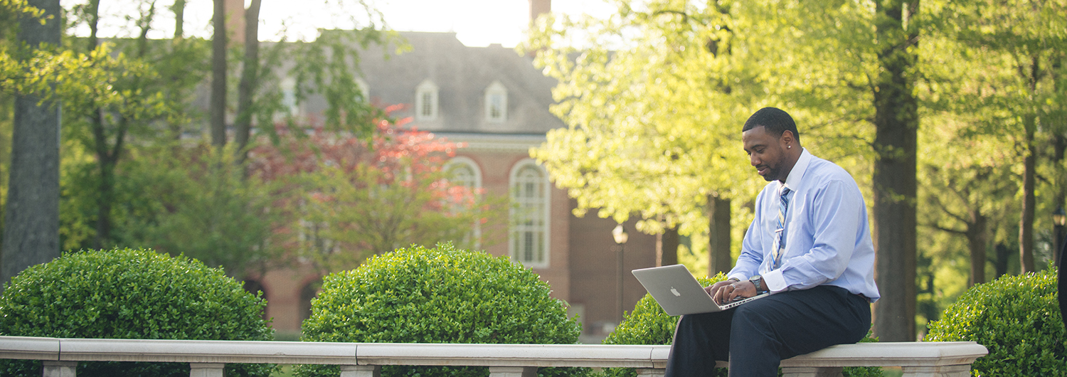 A student works on his laptop at Regent: Explore the Communication degree programs offered by Regent University, online and in Virginia Beach, VA 23464.