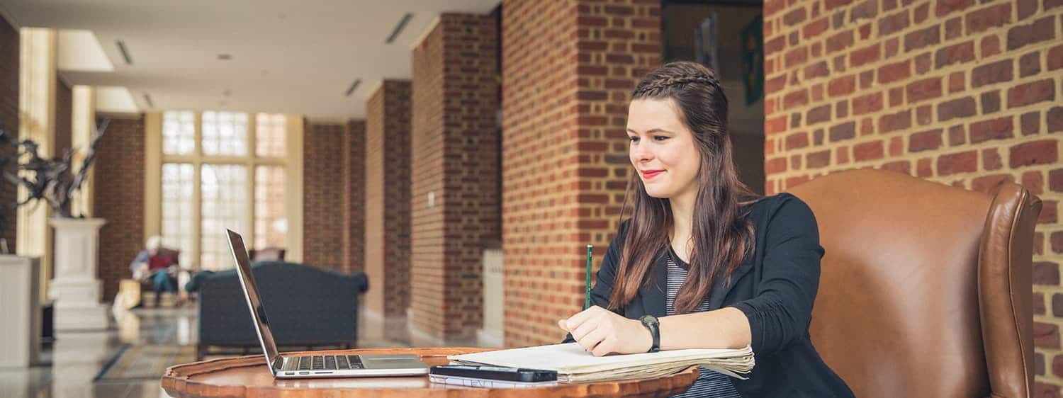 Student writing at Regent University in Virginia Beach.