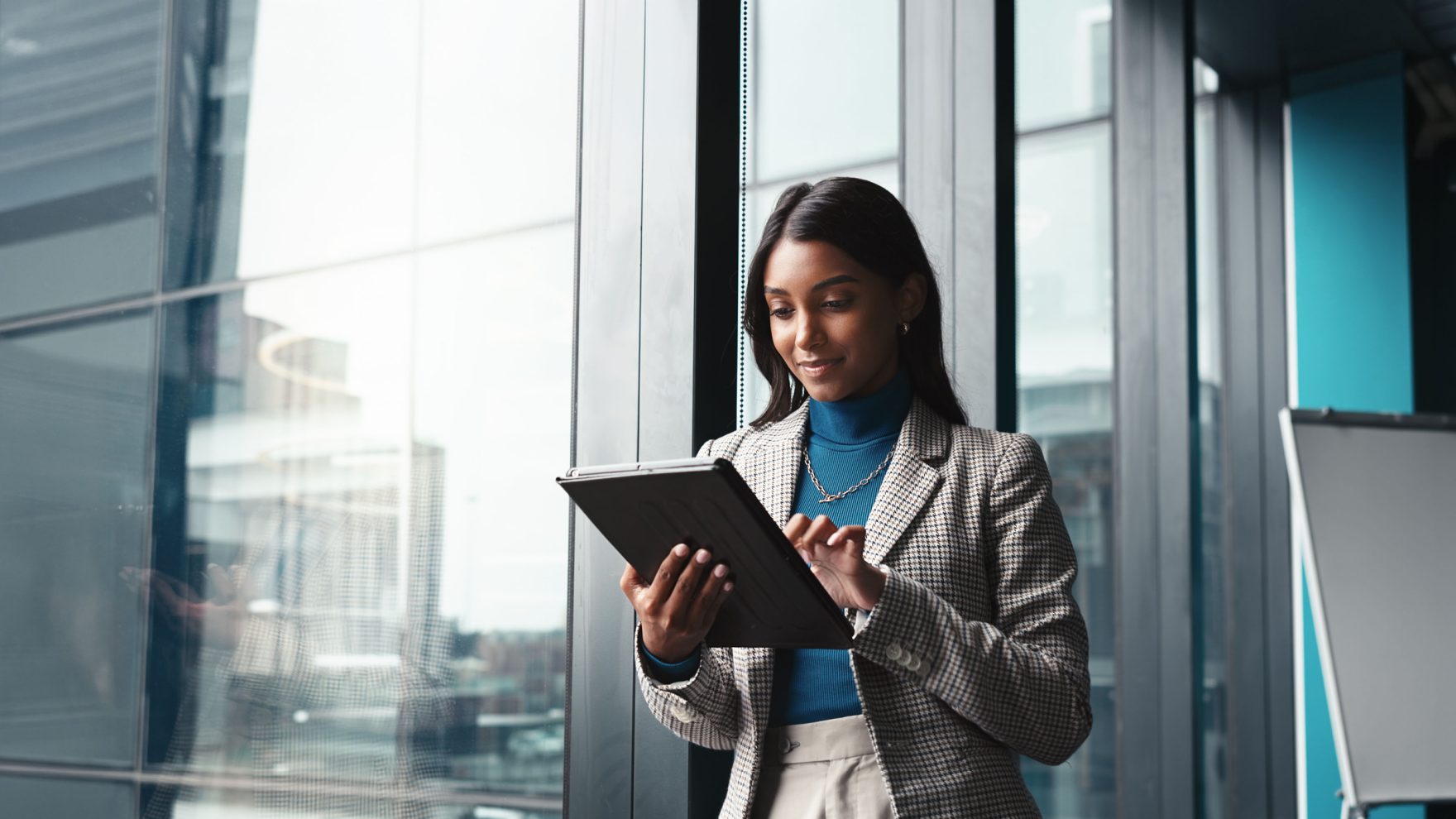 A professional in a building's lobby: Pursue an online graduate certificate in leadership program at Regent University.