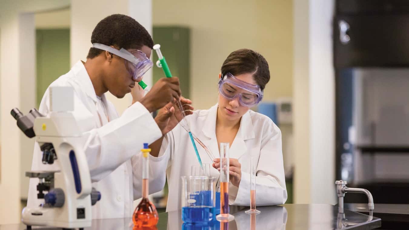 College students perform a science experiment at Regent University, Virginia Beach.