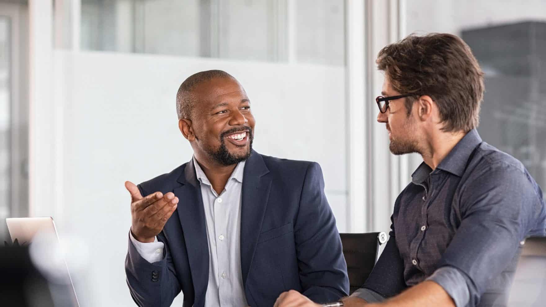 A financial consultant talking to his client: Explore the bachelor's in business financial management at Regent University.