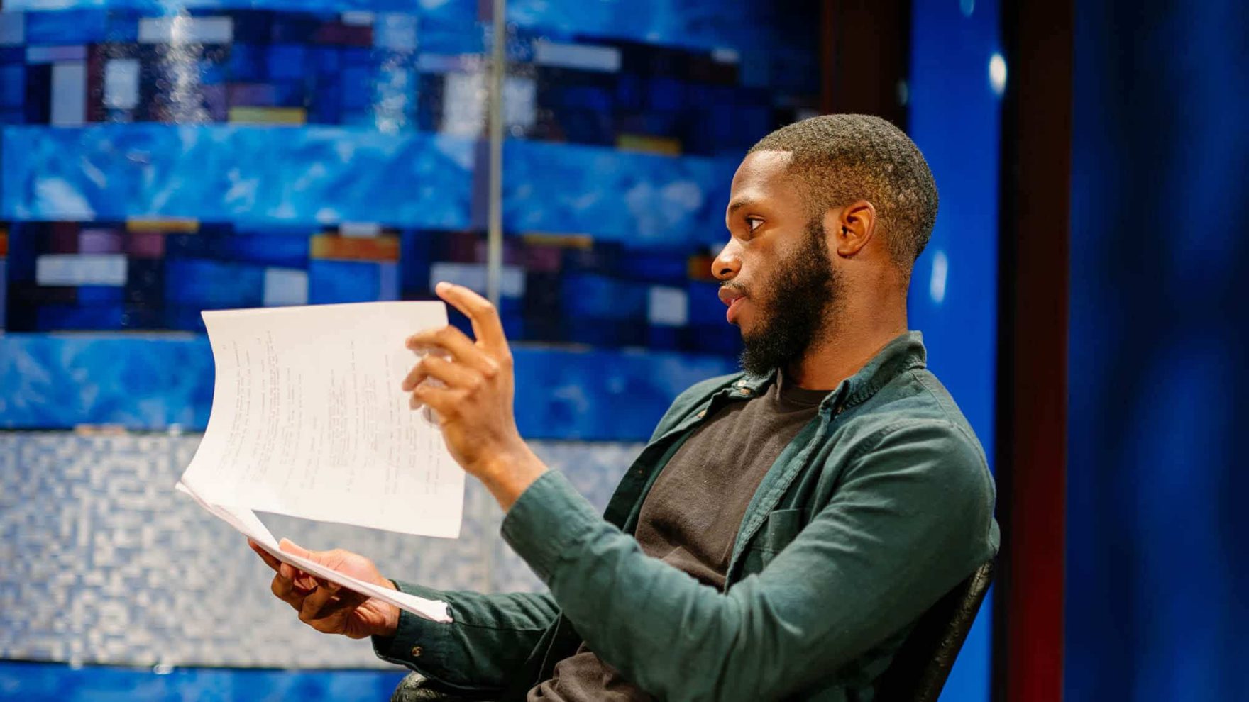 A Regent student holds a script: Explore the MFA screenwriting degree program.
