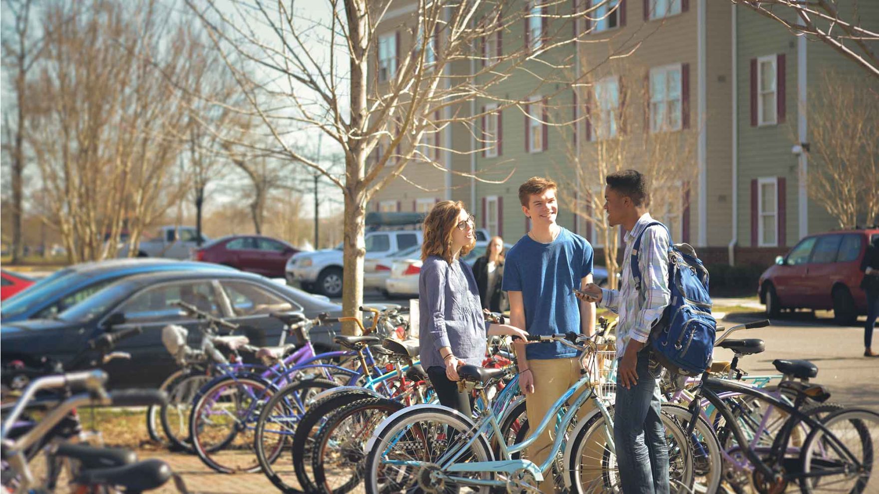 Students converse on campus at Regent University. Learn more about college readiness.