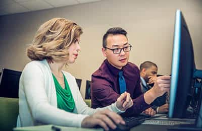 Two professionals in discussion: Explore career services at Regent University Virginia Beach.