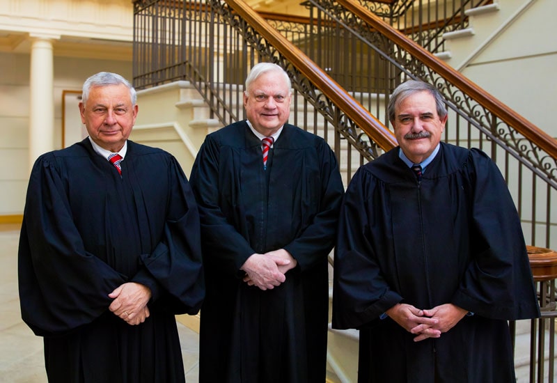 Judges Glen A. Huff, Robert J. Humphreys, and Clifford L. Athey of the Virginia Court of Appeals standing in Regent University’s law school atrium