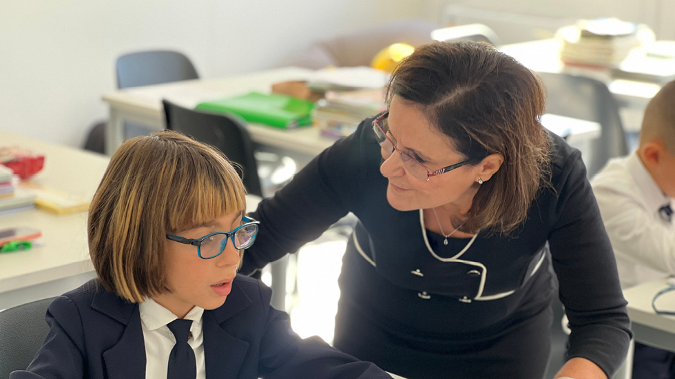 Klementina Shahini in classroom with a student at Lezhe Academic Center