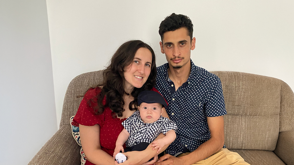 Regent University alumna Hannah Căldăraru is pictured with her husband, Tavi, and their infant son.