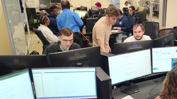Students working at computer workstations during the Regent University Cybersecurity Capture the Flag competition