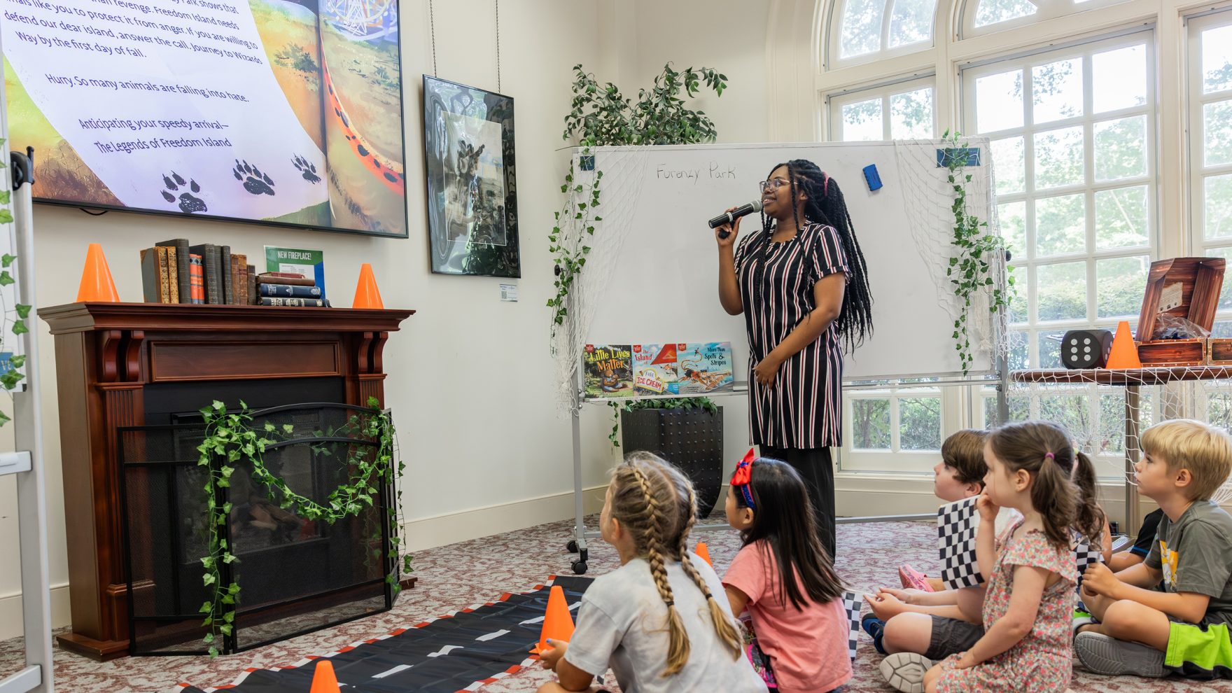 Regent University Library staff member reading to Hampton Roads community kids for storytime.