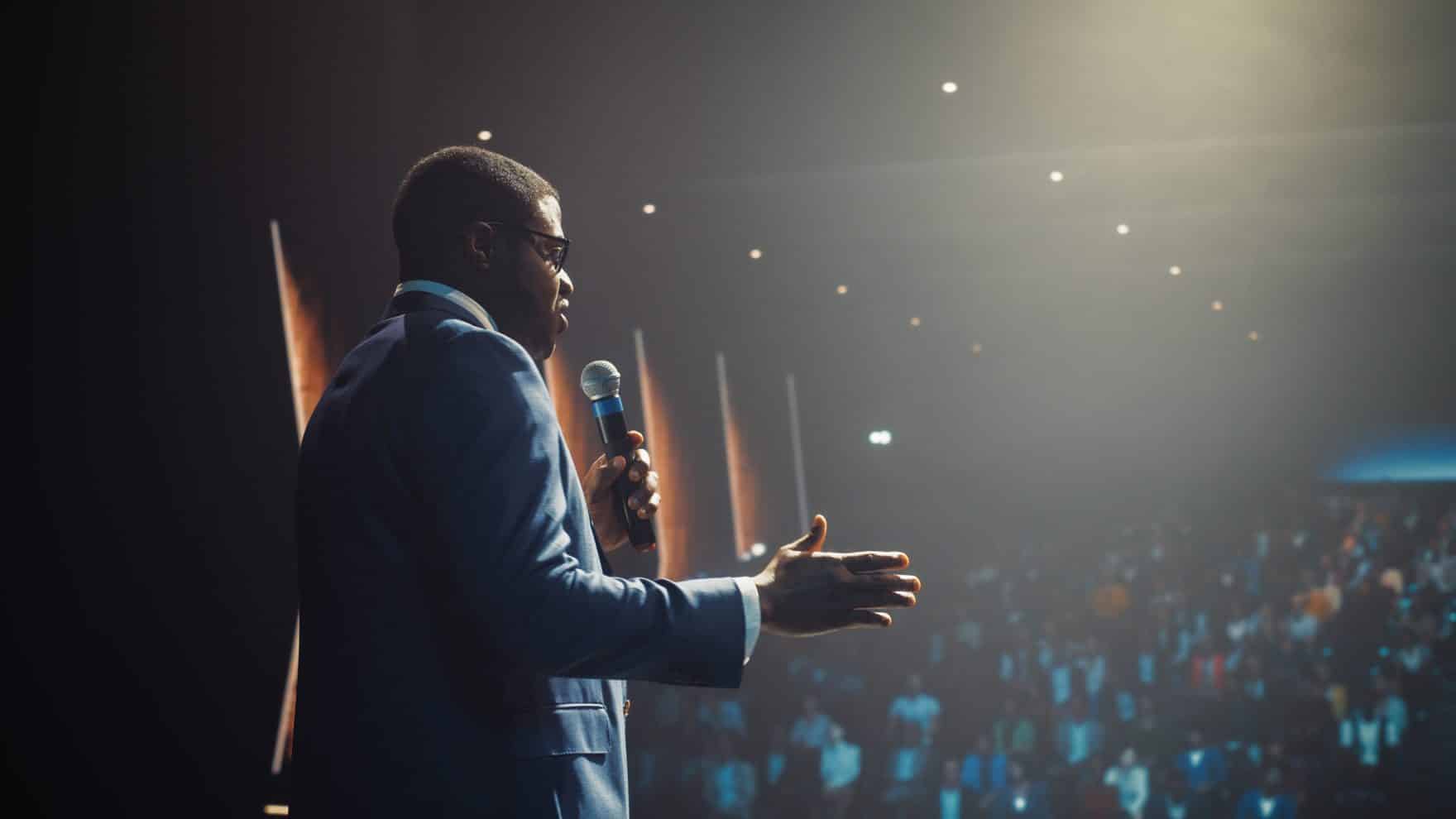Communications professional speaking in front of a crowd.