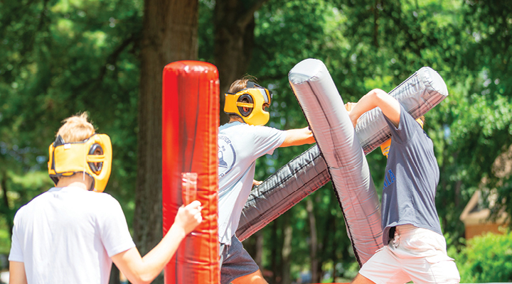 Students participating in outdoor activities during the First Friday event on the Regent University campus