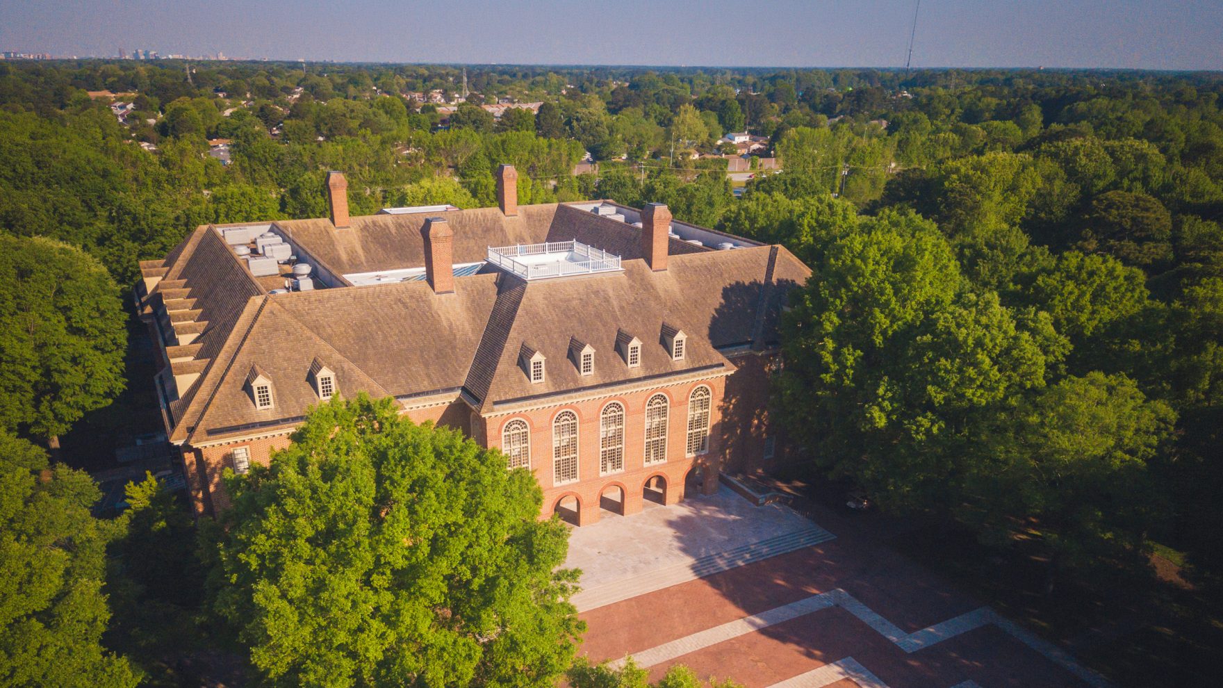 Regent University Library building, surrounded by trees on the campus in Virginia Beach, Virginia.